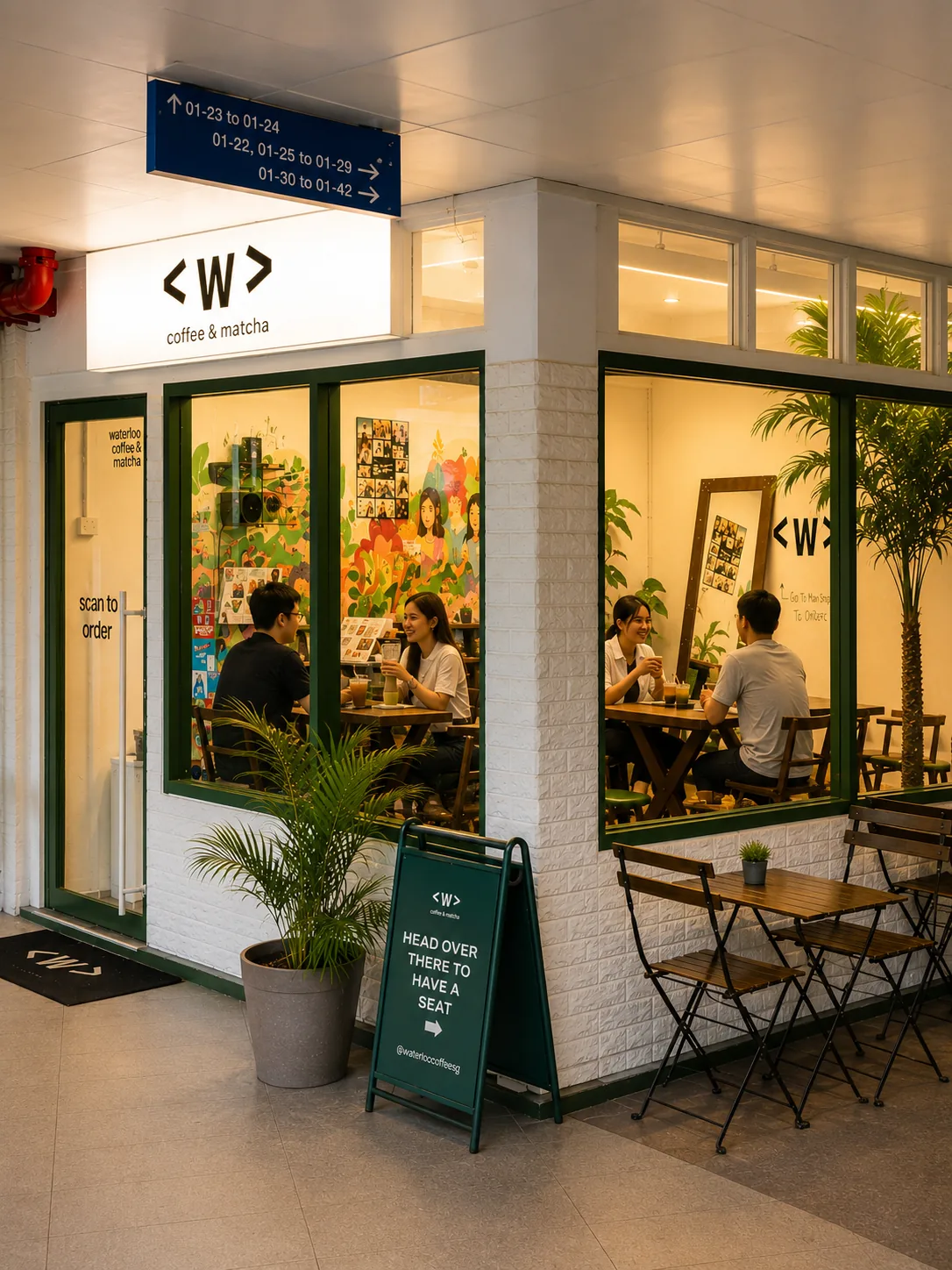 Waterloo Coffee café storefront with warm interior lighting and outdoor seating